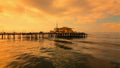 Pier extending into the ocean with a sunset sky.Print by Lisa Lake Photography.