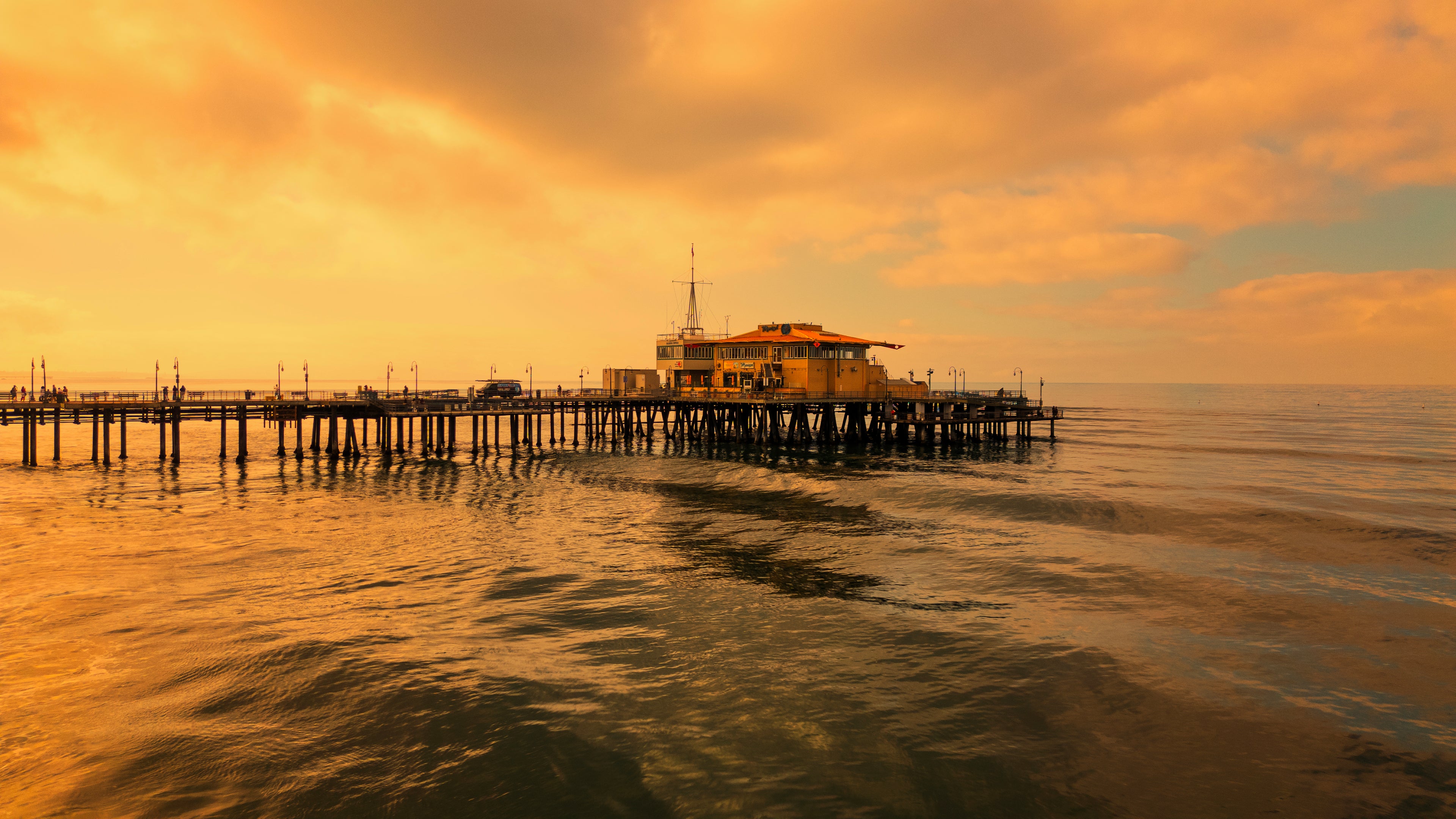 Pier extending into the ocean with a sunset sky.Print by Lisa Lake Photography.